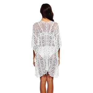 Detailed back view of a white crochet beach cover-up with intricate geometric knit patterns