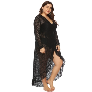 Detailed close-up of intricate floral lace patterns on a long black open-front beach cover-up