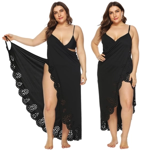 Detail of black plus size beach cover-up featuring intricate floral laser-cut hem design