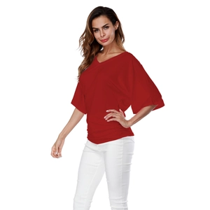 Detail view of the deep red batwing short sleeve top with V-neck and ruched side waist