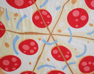 Detailed view of pizza print pattern on soft fabric with pepperoni and cheese motifs