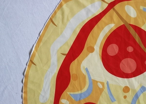 Close-up of circular pizza print blanket showing fabric texture and edge stitching details