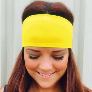Bright yellow elastic headband for women, wide stretch fabric ideal for yoga and sports