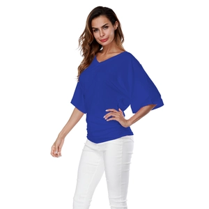 Detail view of v-neck bright blue top featuring batwing sleeves and side rushing design