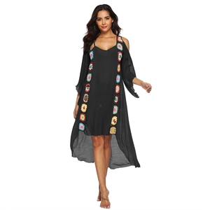Bohemian black beach cover-up with colorful crochet floral details and a curved hem
