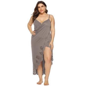 Detail of laser-cut floral patterns and side slit on a grey wrap beach dress