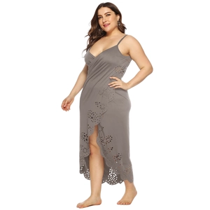 Detail of laser-cut floral pattern on a dark grey plus size beach dress with V-neckline