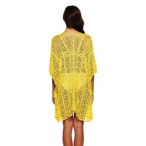 Detailed back view of a bright yellow crochet beach cover-up with intricate fringe edges