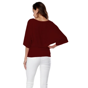 Detail view of wine red batwing sleeve top with pleated waist and loose fit design