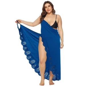 Detail of blue plus size sarong featuring laser-cut floral patterns and wrap-around style
