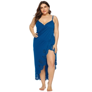 Detail of dark blue wrap beach dress featuring delicate eyelet embroidery and a side slit