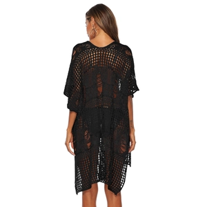 Detailed back view of a black crochet hollow-out beach cover-up with textured knit patterns