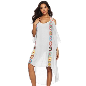 Detailed view of white boho beach dress with colorful crochet trim and cold-shoulder cut