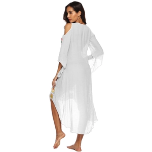 Detailed back view of white cold shoulder dress with ethnic colorful embroidery on hem