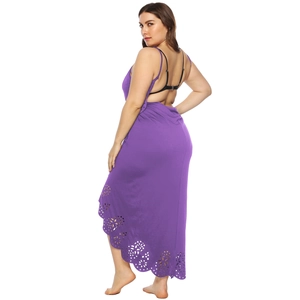 Detailed laser-cut floral patterns on the hem of a purple maxi summer beach dress