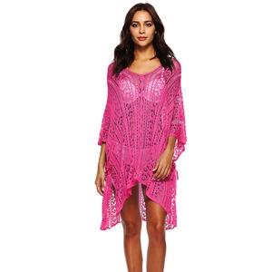 Macro view of bright pink crochet knit pattern on a hollow out V-neck beach cover up