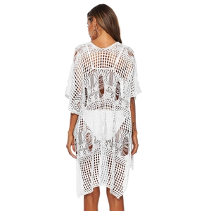 Detailed back view of white crochet knit beach cover-up showing intricate hollow mesh texture