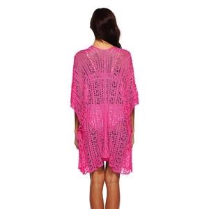 Detailed back view of a bright pink crochet beach cover-up with intricate hollow-out patterns