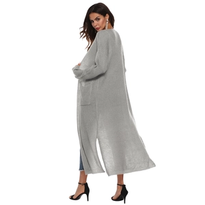Detail of light gray long knit cardigan featuring side slits and functional pockets