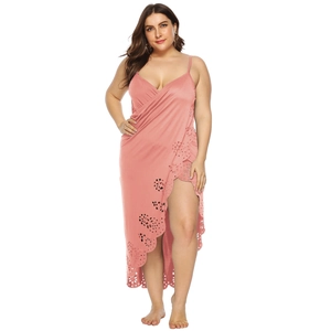 Detail of pink plus size beach cover-up featuring laser-cut floral hem and lace-up wrap design