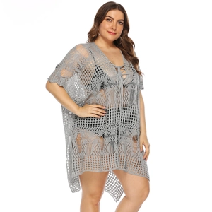 Detail of grey crochet beach cover-up featuring lace-up V-neck and distressed hollow knit
