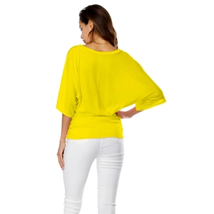 Detail view of yellow V-neck batwing top featuring a cinched waist and loose silhouette