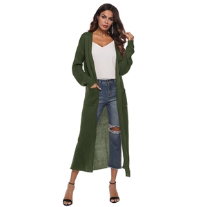 Detail of dark green long knit cardigan with textured fabric and functional pockets