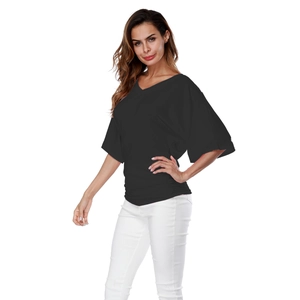 Detail of black V-neck top showing the soft knit texture and side pleats design