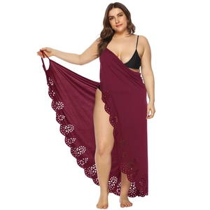 Close-up of the burgundy laser-cut floral details on the edge of the beach sarong
