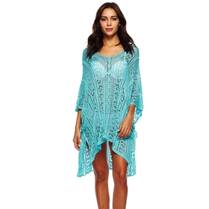 Macro shot of turquoise crochet pattern and intricate hollow out beach cover-up texture