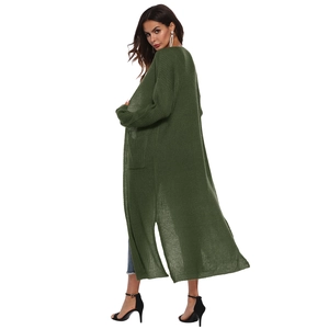 Detail view of long dark green knit cardigan featuring side slits and large side pockets