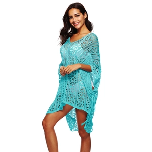 Detail of crochet hollow design on blue beach cover-up with tassel drawstring and V-neckline