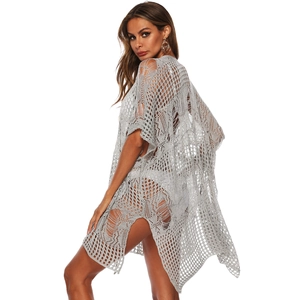 Detail view of the side slit and grey crochet mesh texture on this beach cover-up