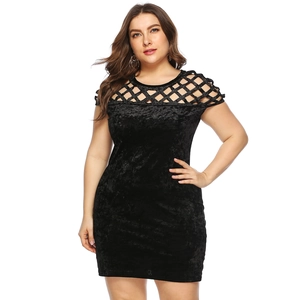 Detail view of the velvet fabric and intricate hollow mesh neckline on the black dress