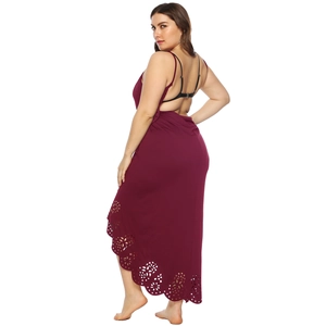 Detail of laser-cut floral hem and open-back design on wine red maxi dress