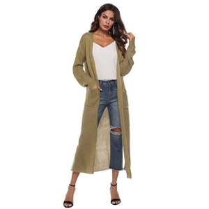Detail view of olive green knit cardigan featuring large side pockets and ribbed texture
