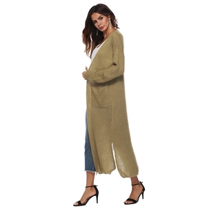 Detail view of long olive knit cardigan featuring deep side slits and large side pockets