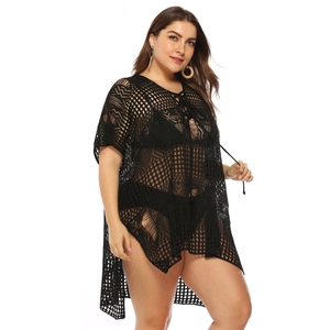 Detail of black crochet beach cover-up with mesh knit texture and side slit design