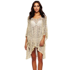 Detail of bohemian crochet lace beach cover-up with intricate hollow floral knit patterns