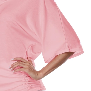 Close-up detail of pink V-neck top featuring batwing sleeves and side ruching texture