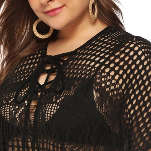 Detail of black hollow-out crochet beach cover-up with lace-up front and mesh texture