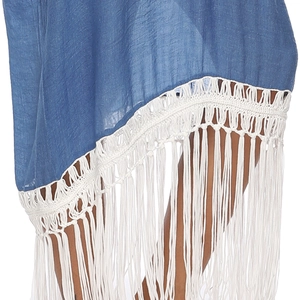 Close-up of blue beach dress with white crochet hem and long tassel fringe details