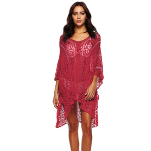 Detail showing red hollow crochet knit texture with V-neck and boho beach cover up style