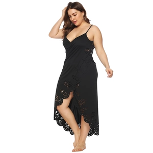 Detail of black beach cover-up with laser-cut floral patterns and V-neckline