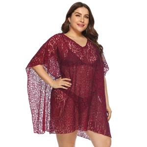 Close-up of wine red lace hollow-out beach cover-up with intricate floral texture