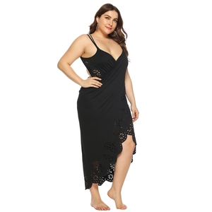 Detail of laser-cut floral patterns on the hem of a black plus size beach wrap dress