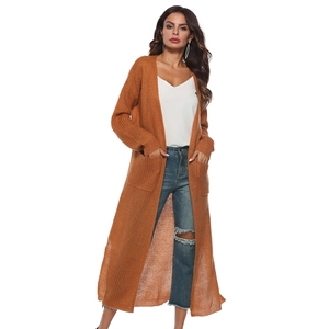Detail of caramel knit cardigan featuring thick texture, open front and large side pockets