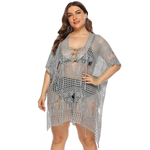 Close-up of grey crochet knit beach cover-up with intricate hollow pattern and front ties