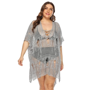 Detail of grey oversized crochet beach cover-up featuring hollow-out knit texture
