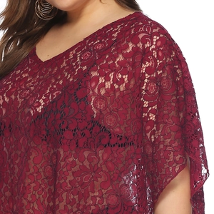Detail of burgundy lace beach cover-up with intricate floral hollow patterns and V-neckline